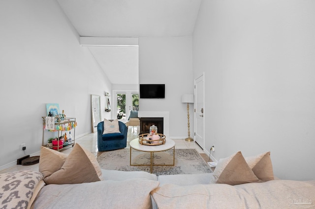 tiled living room with high vaulted ceiling