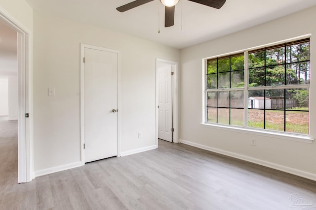 8123 Mobile Hwy, Pensacola, FL 32526 - unfurnished bedroom with wood finished floors, baseboards, and a ceiling fan