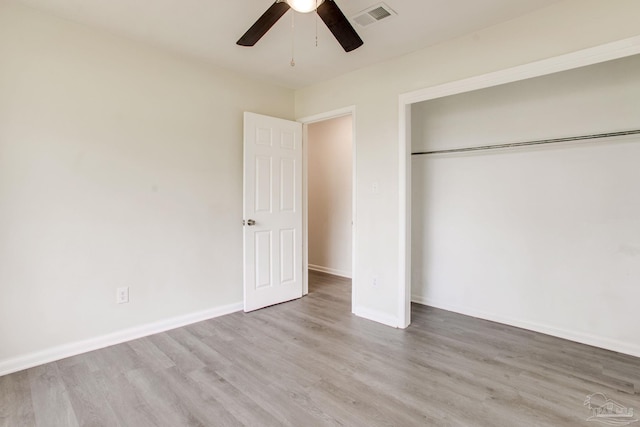 8123 Mobile Hwy, Pensacola, FL 32526 - unfurnished bedroom featuring wood finished floors, a closet, baseboards, and a ceiling fan