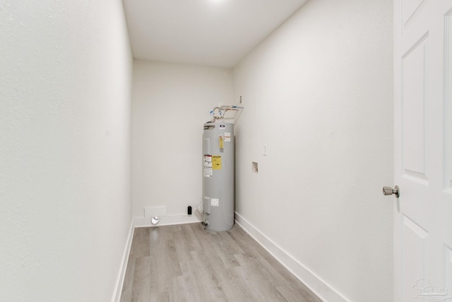 8123 Mobile Hwy, Pensacola, FL 32526 - washroom with water heater, light wood finished floors, and baseboards