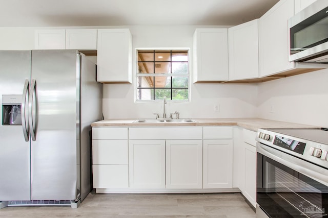 8123 Mobile Hwy, Pensacola, FL 32526 - kitchen with appliances with stainless steel finishes, a sink, and white cabinetry