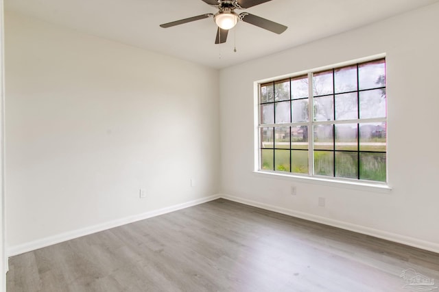 8123 Mobile Hwy, Pensacola, FL 32526 - unfurnished room featuring wood finished floors, plenty of natural light, and baseboards