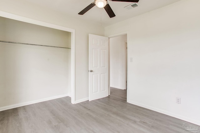 8123 Mobile Hwy, Pensacola, FL 32526 - unfurnished bedroom with wood finished floors, a closet, baseboards, and ceiling fan