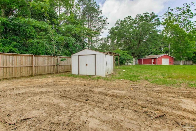 8123 Mobile Hwy, Pensacola, FL 32526 - view of yard with fence, an outdoor structure, a storage shed, and view of scattered trees