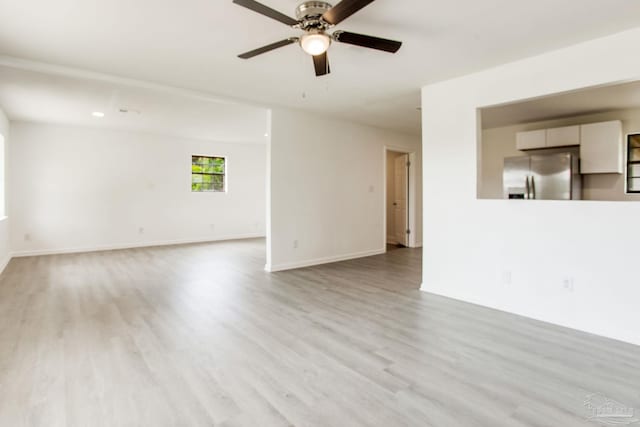 8123 Mobile Hwy, Pensacola, FL 32526 - unfurnished living room with light wood-style floors, ceiling fan, and baseboards