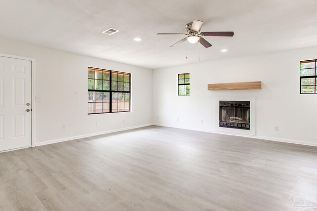 8123 Mobile Hwy, Pensacola, FL 32526 - unfurnished living room with wood finished floors, plenty of natural light, a fireplace, and recessed lighting