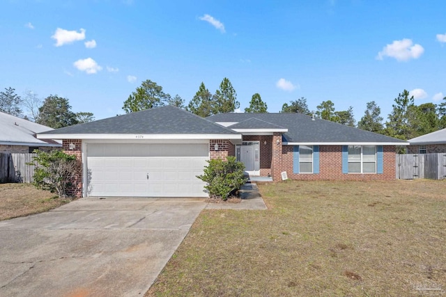 ranch-style home featuring a garage and a front lawn