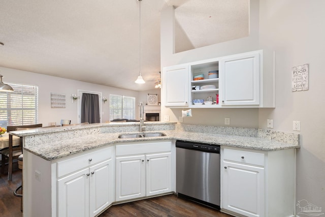 kitchen featuring sink, dishwasher, white cabinetry, hanging light fixtures, and kitchen peninsula