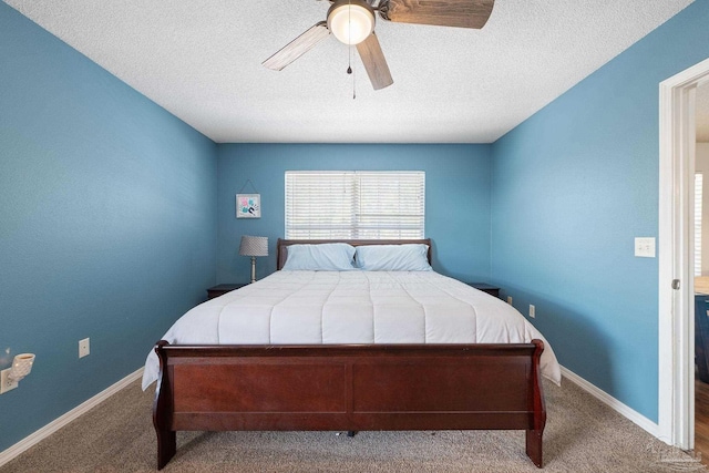 carpeted bedroom featuring a textured ceiling and ceiling fan