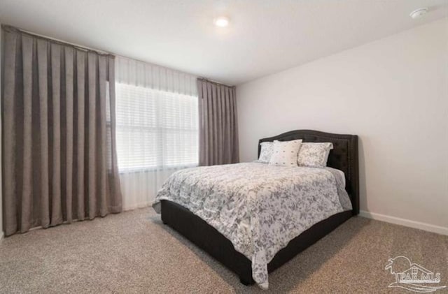 bedroom with light colored carpet