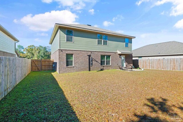 rear view of property with a patio area and a yard
