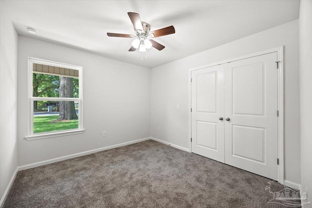 5621 Kingery Rd, Milton, FL 32583 - unfurnished bedroom featuring carpet flooring, baseboards, a closet, and ceiling fan