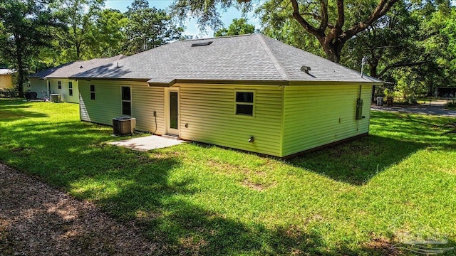 5621 Kingery Rd, Milton, FL 32583 - back of property with central AC, a yard, and a shingled roof