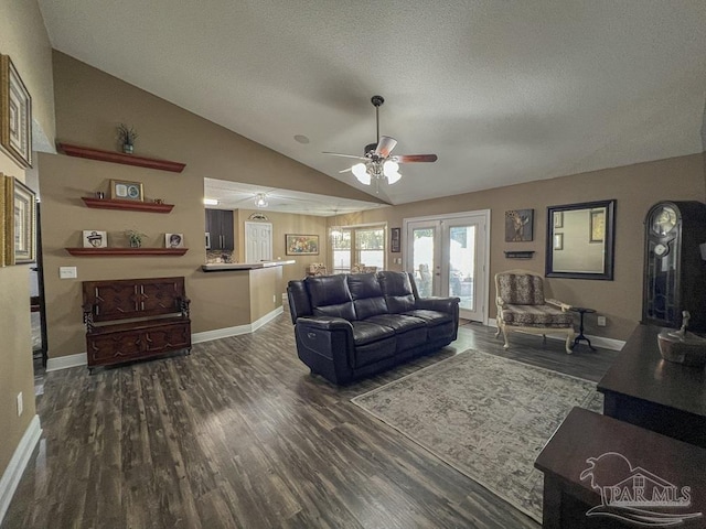 living room with french doors, dark hardwood / wood-style flooring, a textured ceiling, ceiling fan, and lofted ceiling