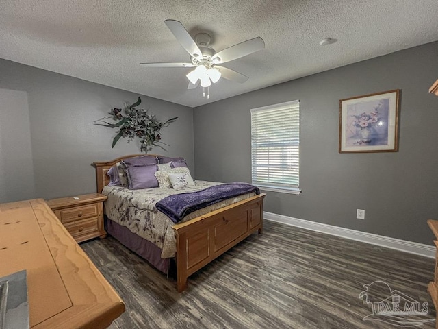 bedroom with ceiling fan, dark hardwood / wood-style floors, and a textured ceiling