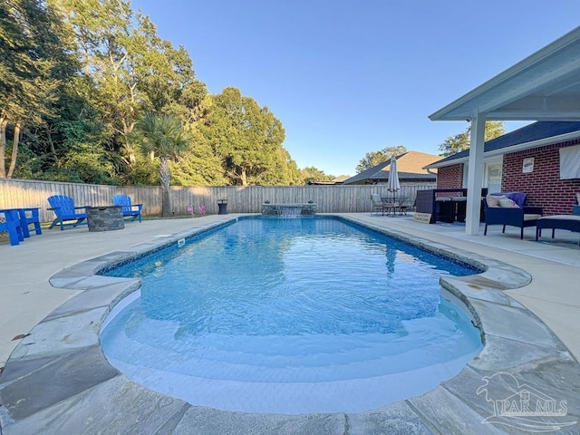 view of pool with a fire pit and a patio area