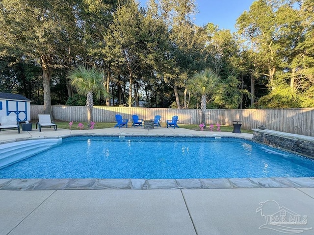 view of swimming pool featuring a patio and pool water feature