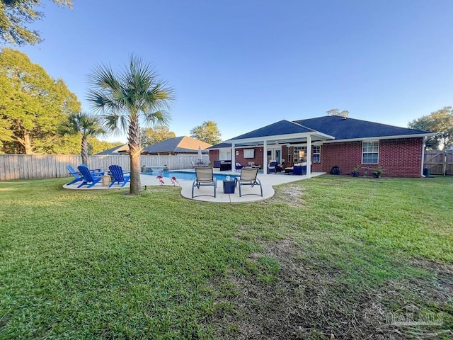 view of yard featuring a fenced in pool, an outdoor living space, and a patio