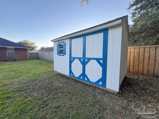 view of outdoor structure featuring a lawn