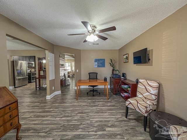 home office featuring ceiling fan, wood-type flooring, and a textured ceiling