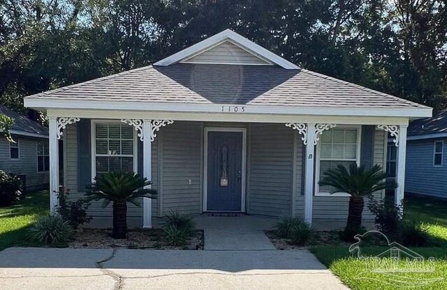 view of front of home featuring a porch and a front lawn