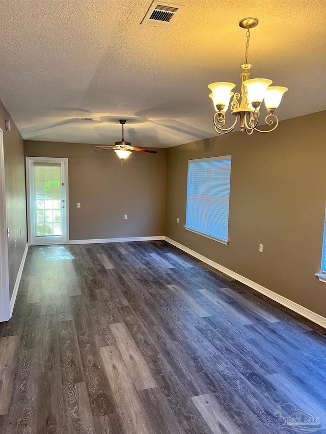 empty room featuring dark hardwood / wood-style floors, ceiling fan with notable chandelier, and a textured ceiling