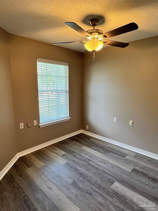 unfurnished room with dark wood-style floors, a textured ceiling, a ceiling fan, and baseboards