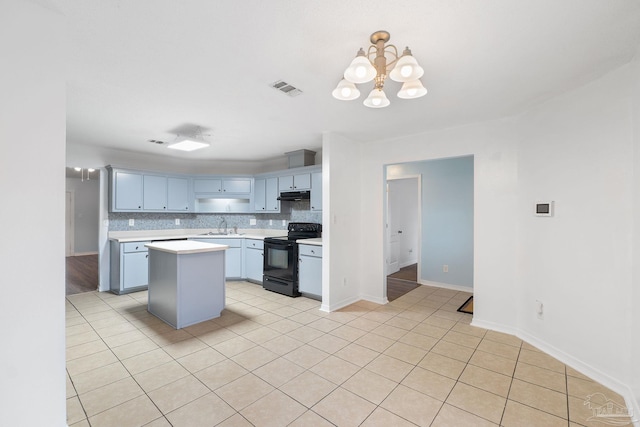 kitchen featuring a kitchen island, decorative light fixtures, tasteful backsplash, sink, and black / electric stove