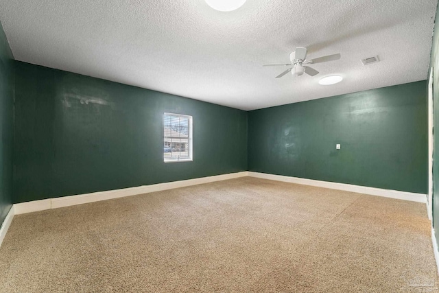 unfurnished room with ceiling fan, carpet, and a textured ceiling