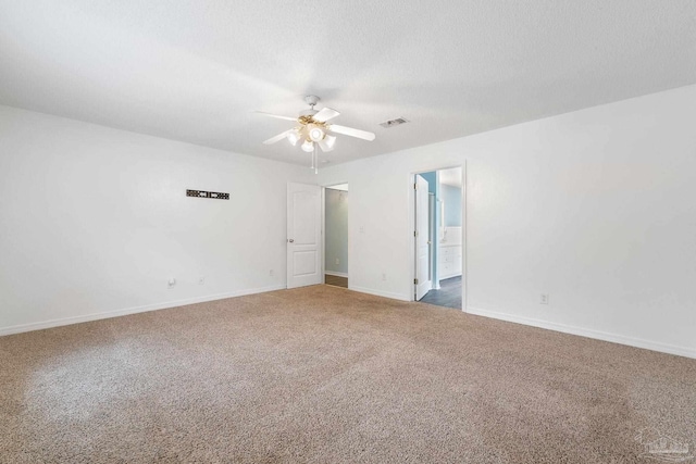 carpeted spare room featuring a textured ceiling and ceiling fan