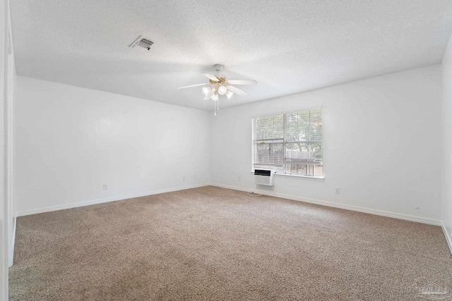 spare room featuring ceiling fan, carpet flooring, and a textured ceiling