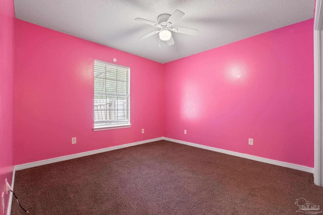 spare room featuring ceiling fan, carpet, and a textured ceiling