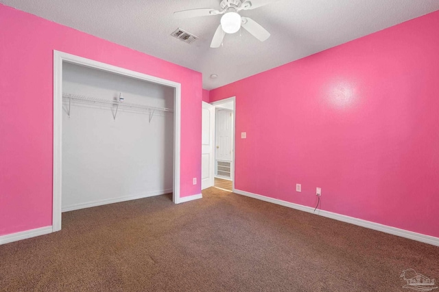 unfurnished bedroom featuring ceiling fan, a closet, carpet, and a textured ceiling