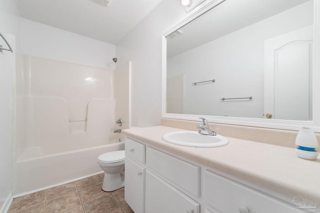 full bathroom featuring vanity, tile patterned floors, toilet, and washtub / shower combination