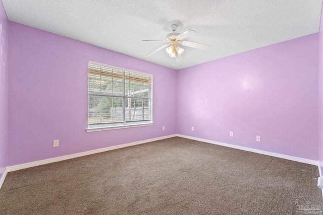 carpeted spare room with a textured ceiling and ceiling fan