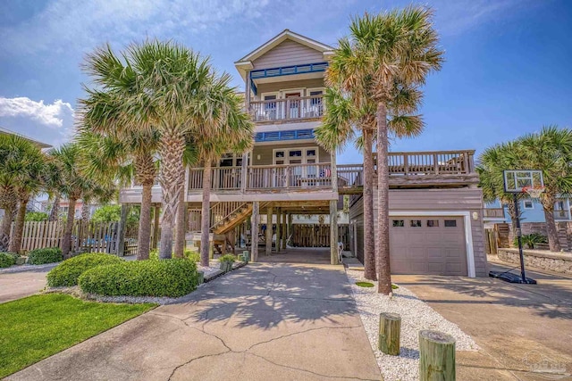 view of front of house featuring a balcony, a carport, a porch, and a garage