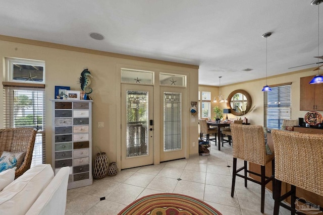 living room with ornamental molding, french doors, and light tile patterned flooring