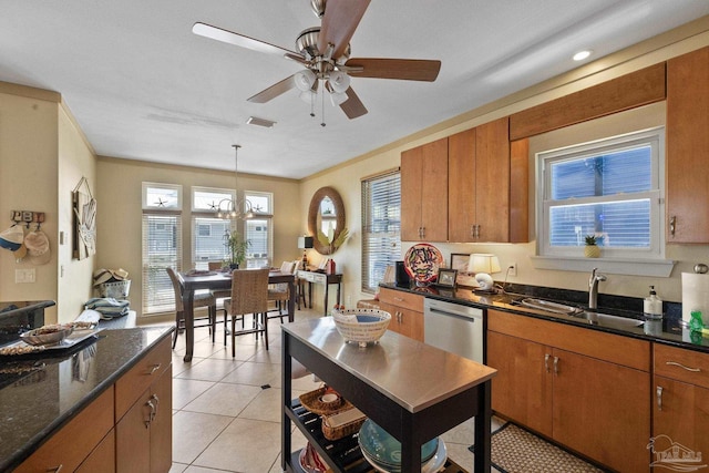 kitchen featuring sink, hanging light fixtures, ornamental molding, light tile patterned flooring, and stainless steel dishwasher