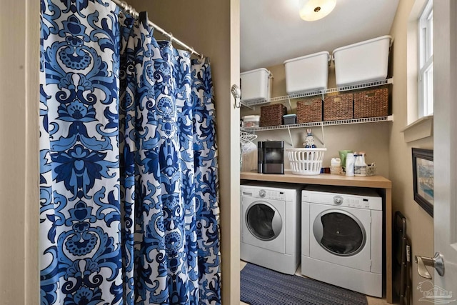 clothes washing area featuring separate washer and dryer