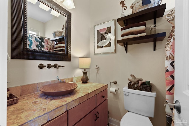 bathroom featuring toilet and vanity