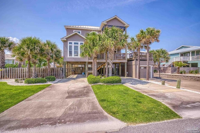 view of front of home featuring a garage, a front lawn, and a carport