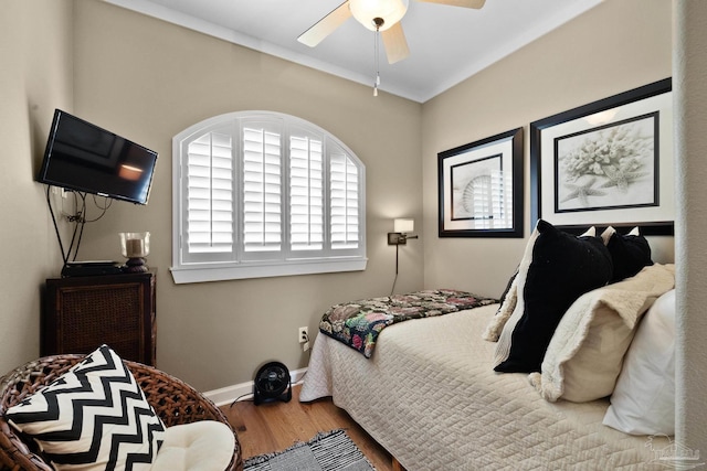 bedroom with ceiling fan and wood-type flooring