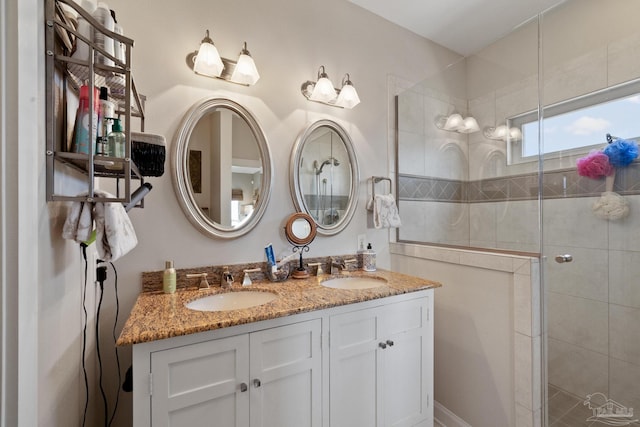 bathroom featuring walk in shower and vanity