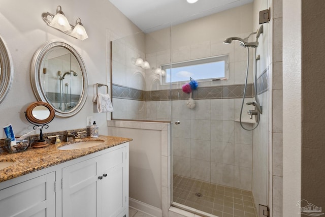 bathroom with vanity and a shower with door