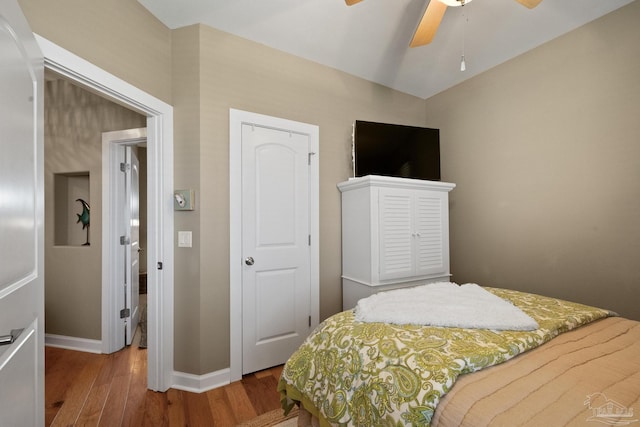 bedroom with ceiling fan and hardwood / wood-style floors