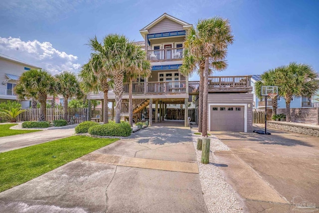 view of front of home featuring a balcony, a carport, a porch, and a garage