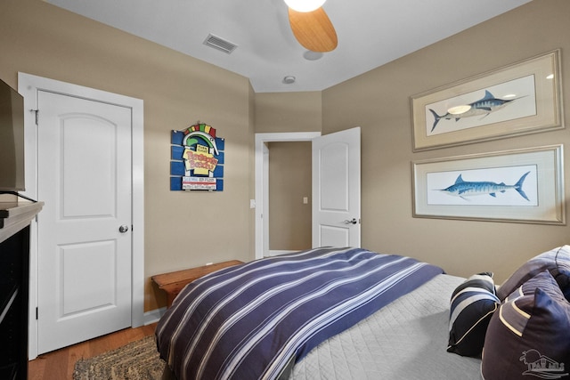 bedroom with ceiling fan and hardwood / wood-style floors