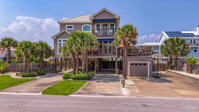 view of front of home with a balcony, a garage, and a carport