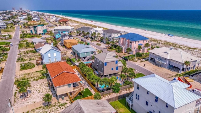 drone / aerial view with a water view and a beach view