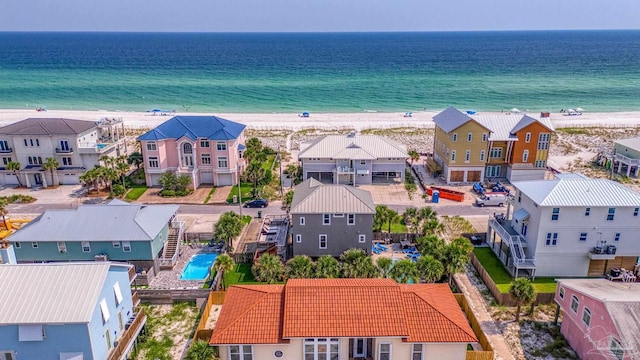 drone / aerial view featuring a water view and a beach view